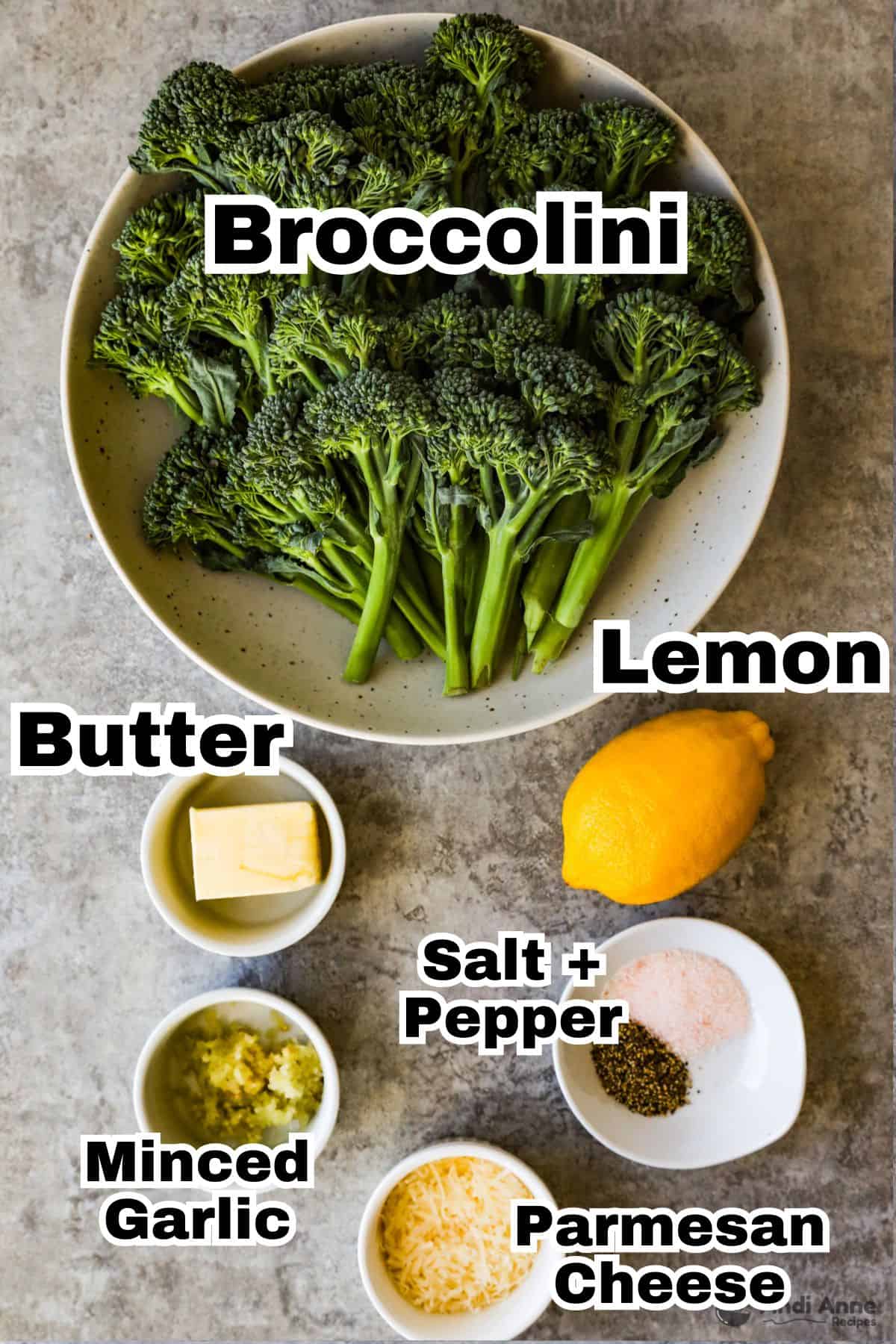 Recipe ingredients in bowls including raw broccolini, some butter, a lemon, fresh mined garlic, shredded parmesan cheese, salt and pepper