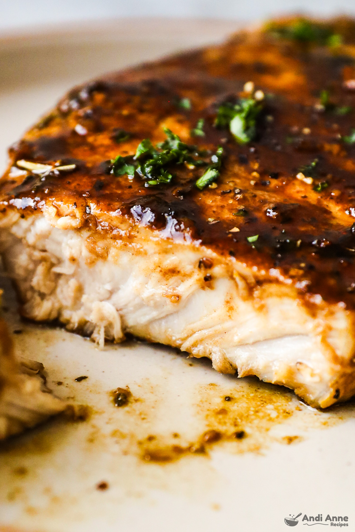 Close up of a slice of pork chop with balsamic glaze sauce