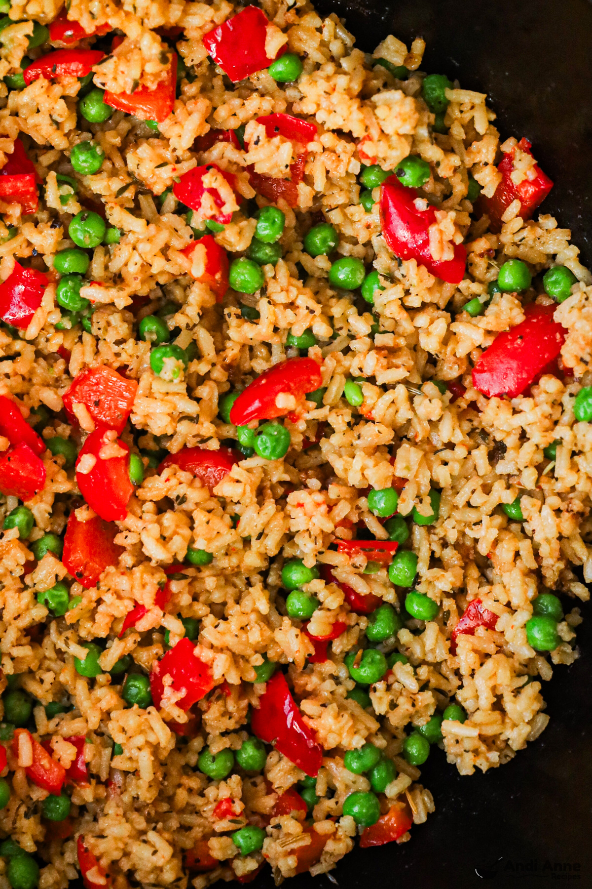 Close up of rice with bell peppers and peas