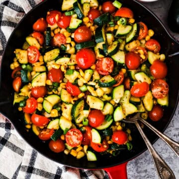 Frying pan with chopped zucchini, corn and tomatoes