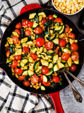 Frying pan with chopped zucchini, corn and tomatoes