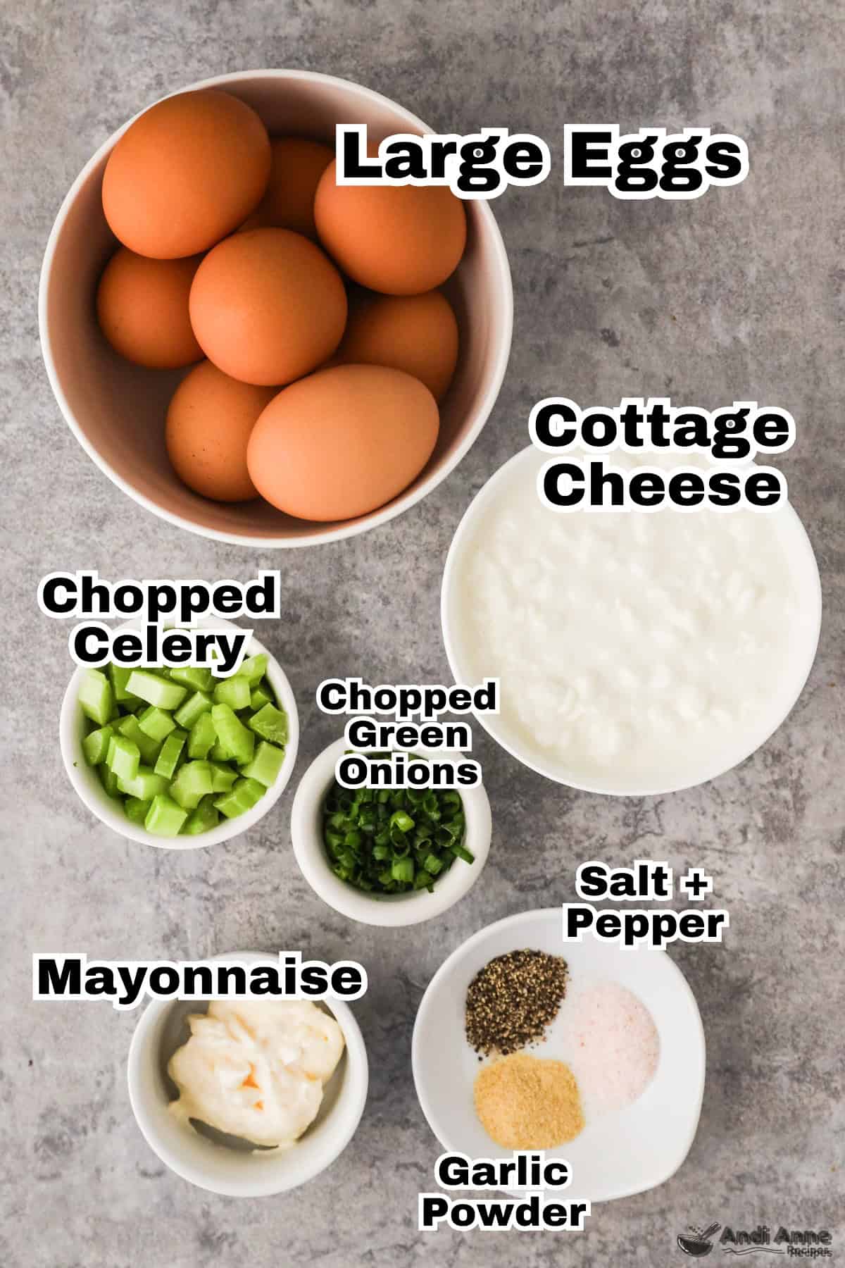 Overhead view of ingredients: Eggs, cottage cheese, chopped celery, chopped green onions, salt, pepper, mayonnaise, garlic powder. 