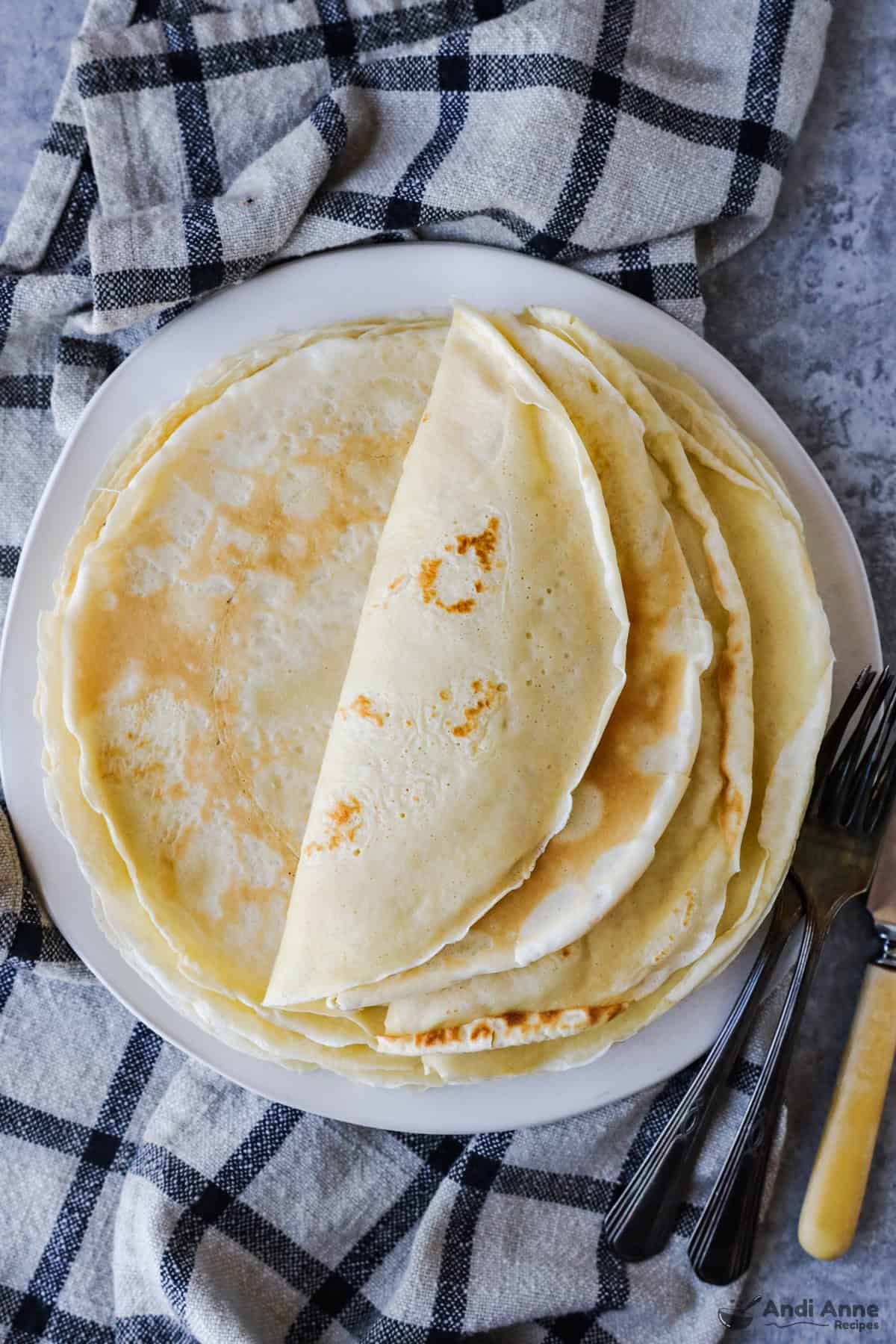 A plate of crepe foled over eachother