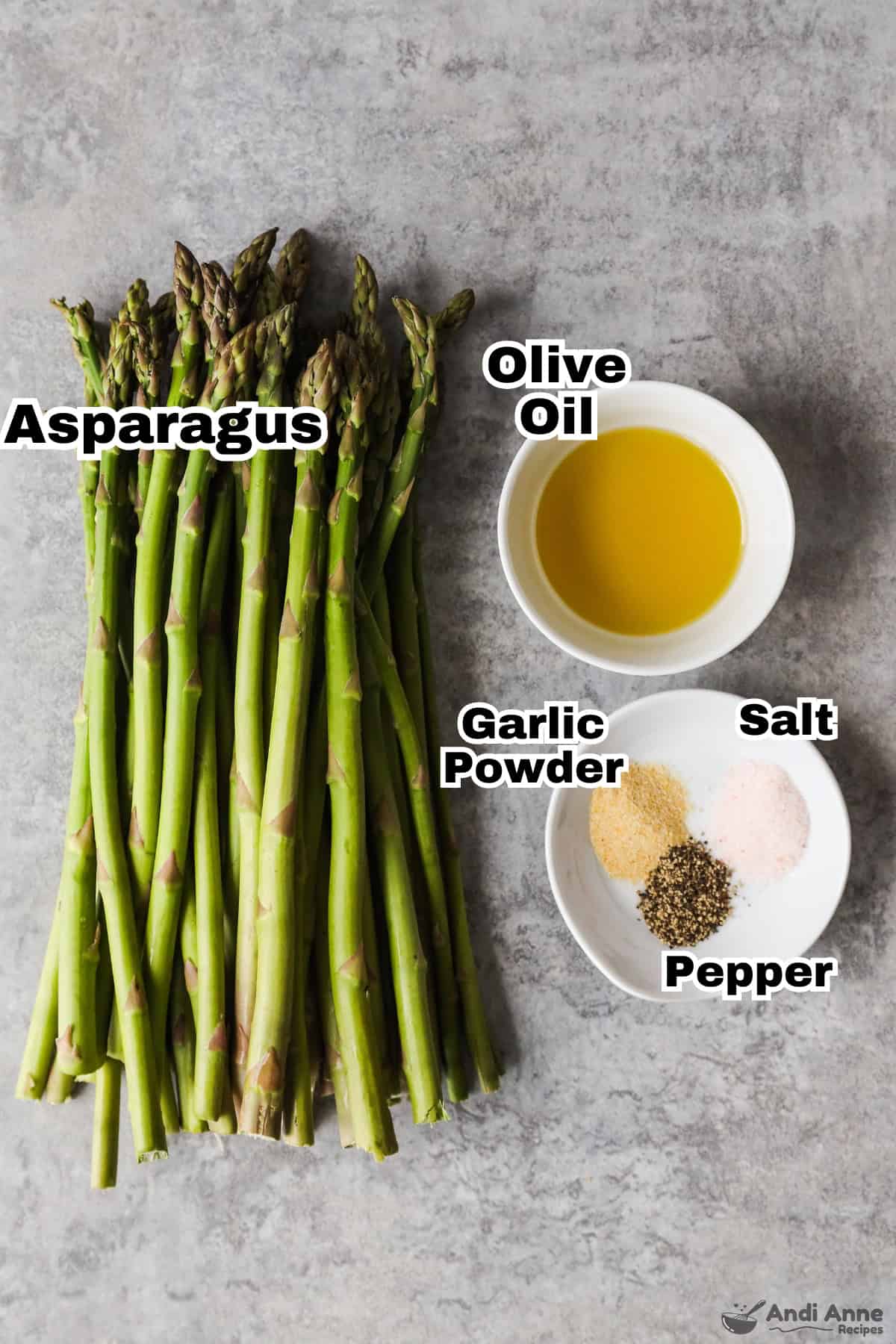 Overhead view of ingredients: Asparagus, Olive oil, garlic powder, salt and pepper. 