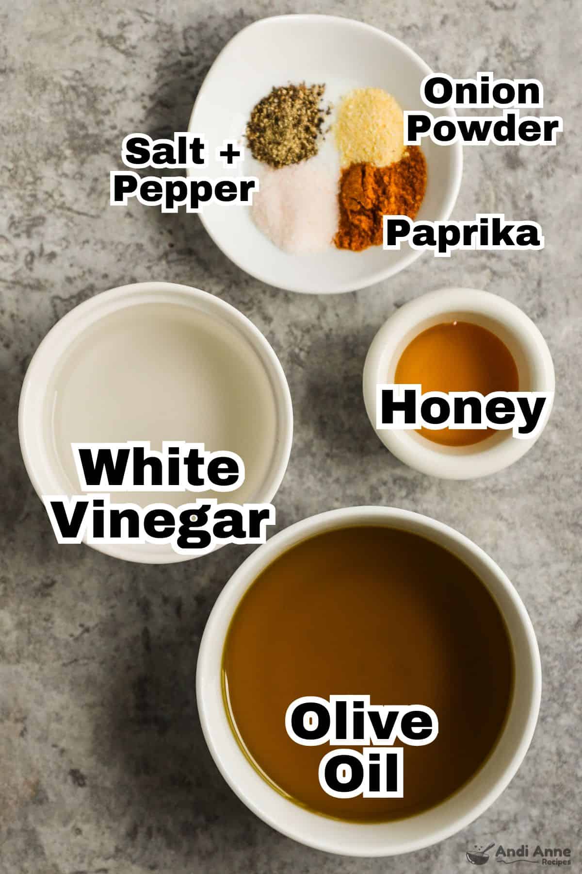 The ingredients to make a classic vinaigrette dressing in small white bowls.