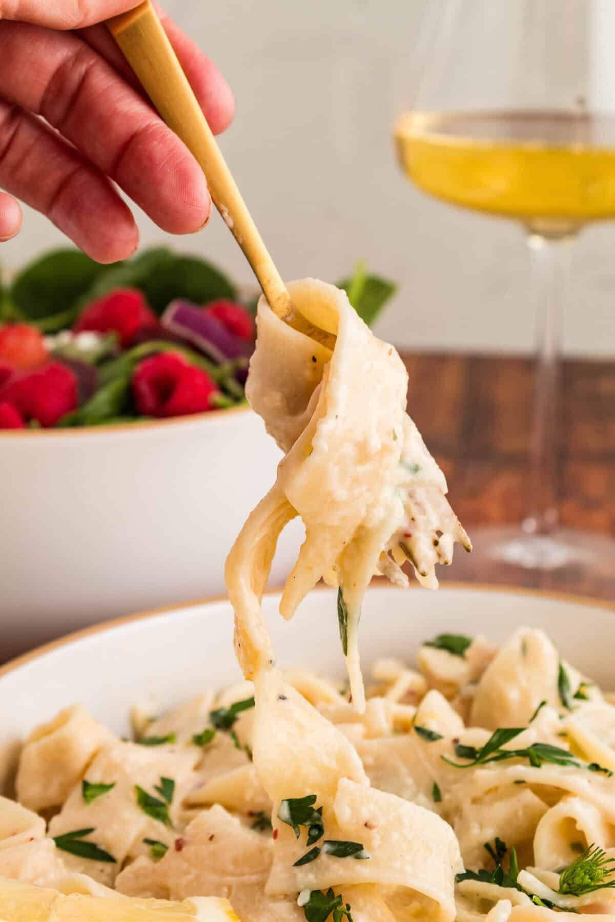 fork with creamy lemon pasta over bowl of pasta
