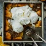 Magic Lemon Cobbler in the pan with a piece removed and two forks.