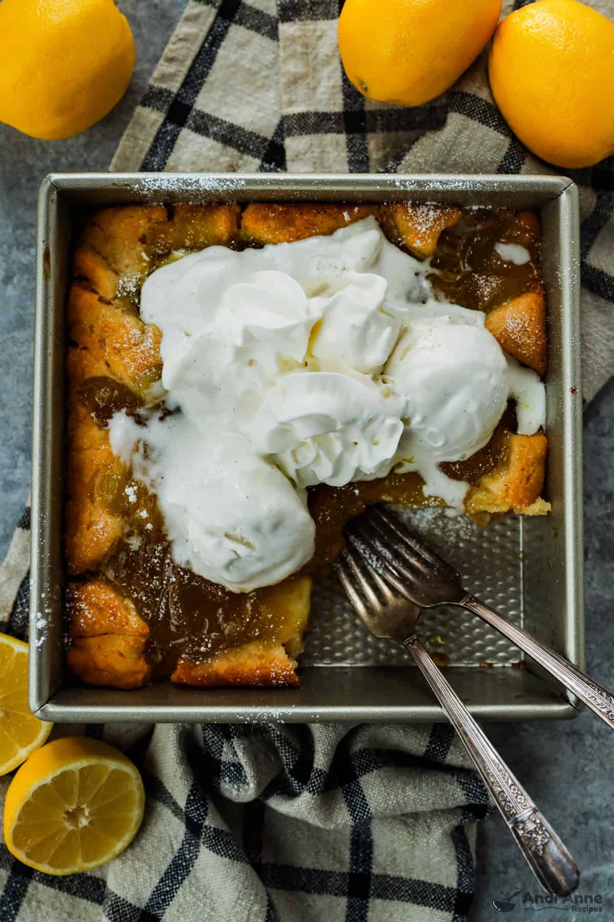 Magic Lemon Cobbler in the pan with a piece removed and two forks.