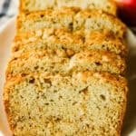 Slices of apple bread lined up on a plate.