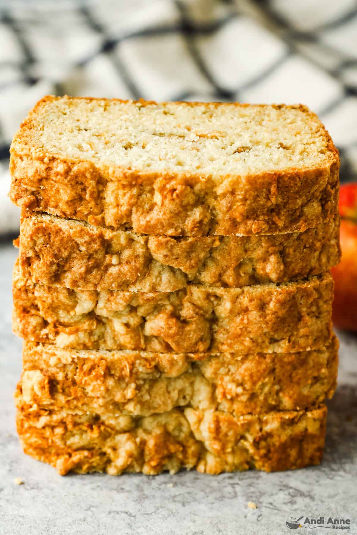 Slices of apple bread are arranged in a stack.
