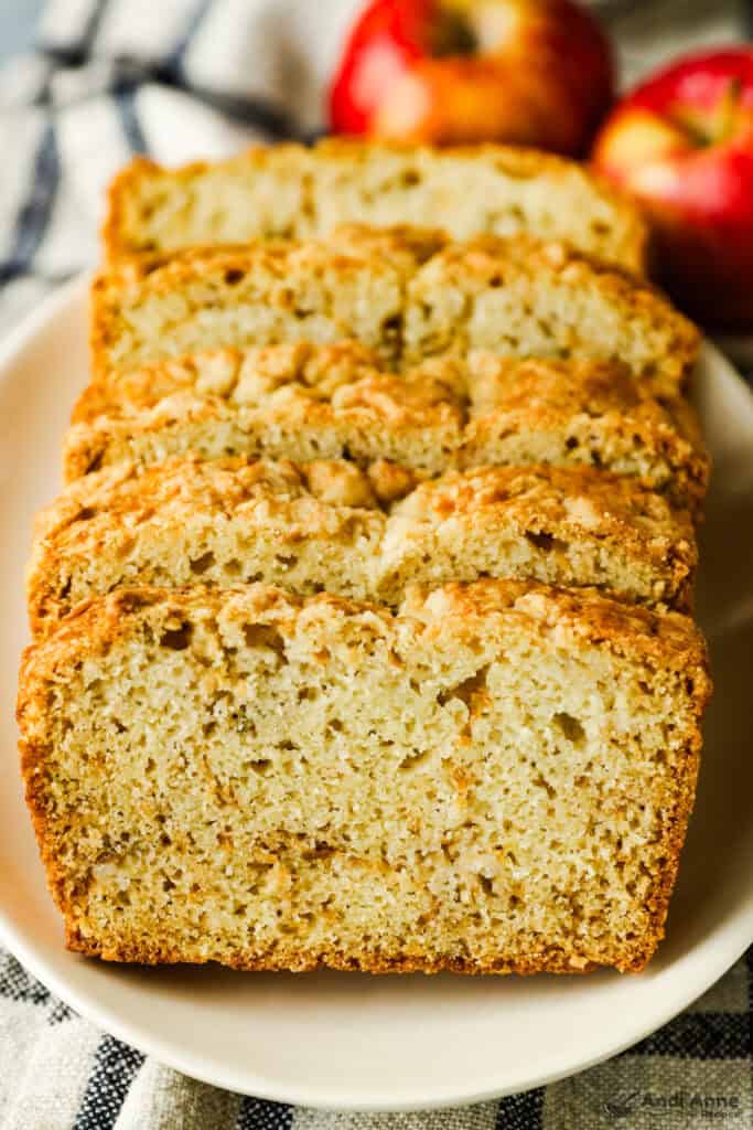 Slices of apple bread lined up on a plate.
