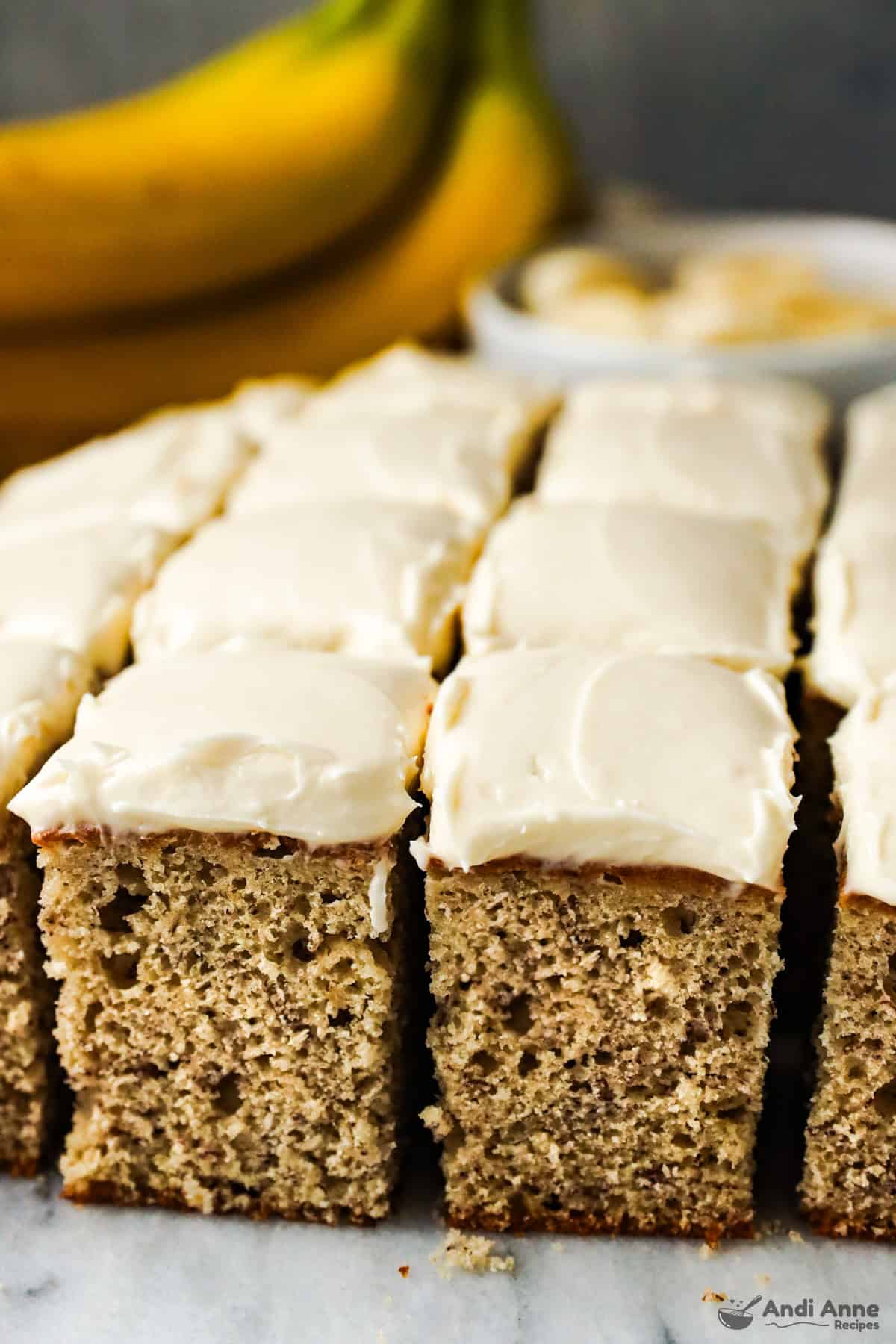 A side view of the slices of banana cake with cream cheese frosting.
