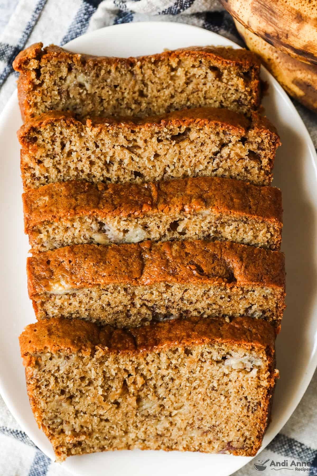 Slices of banana bread in a row on a plate.