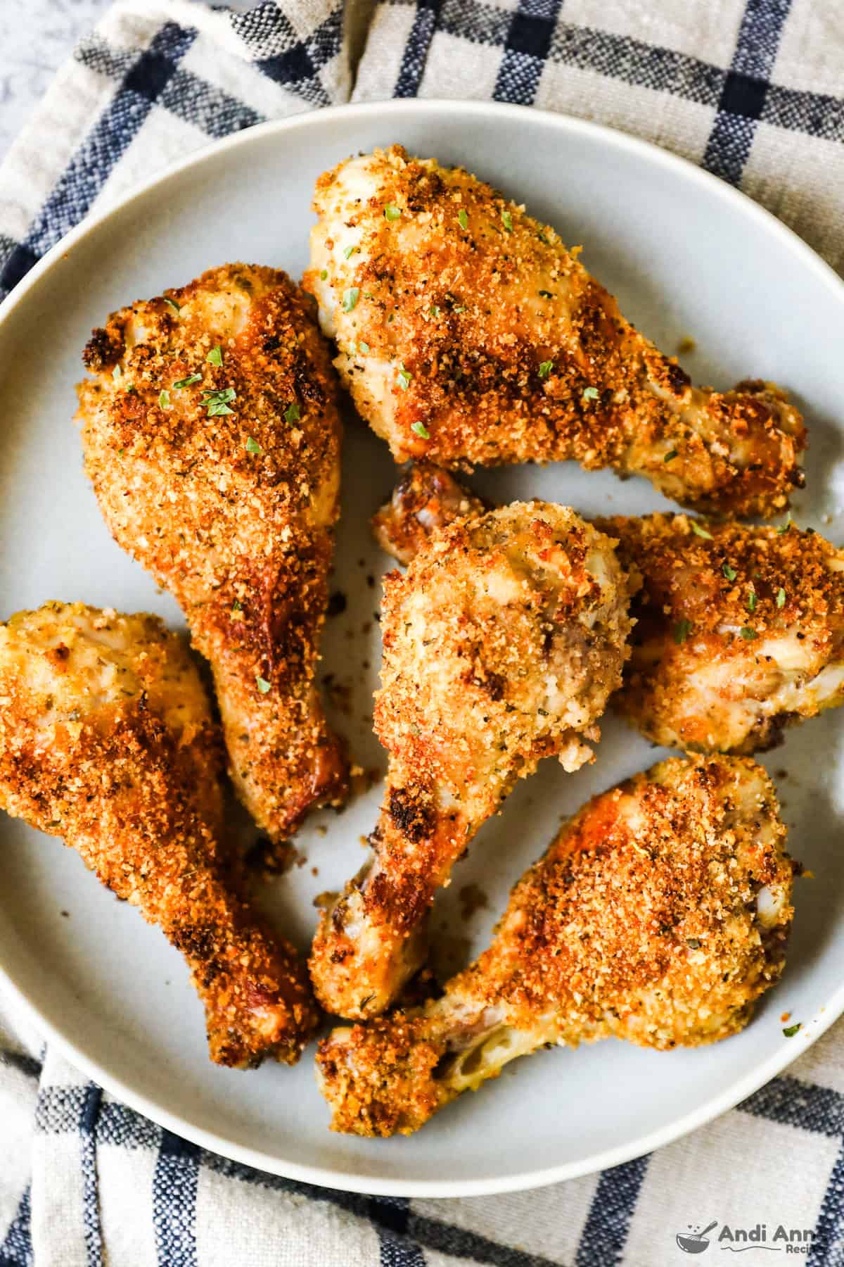 A plate filled with crispy chicken legs coated in homemade shake and bake mix.
