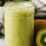 A mason jar full of kiwi citrus salad dressing.