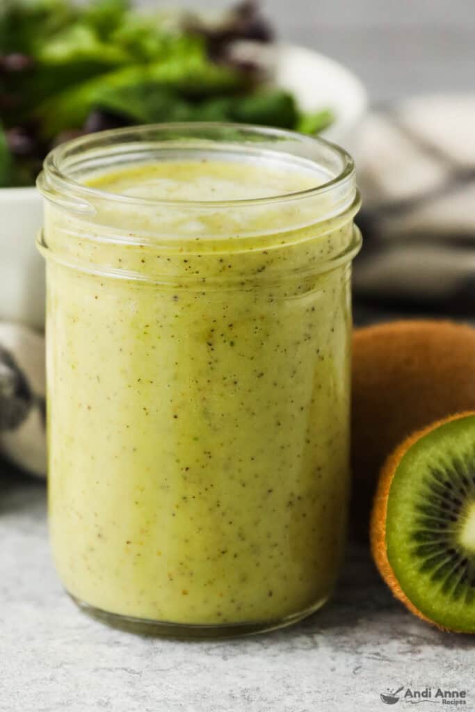 A mason jar full of kiwi citrus salad dressing.