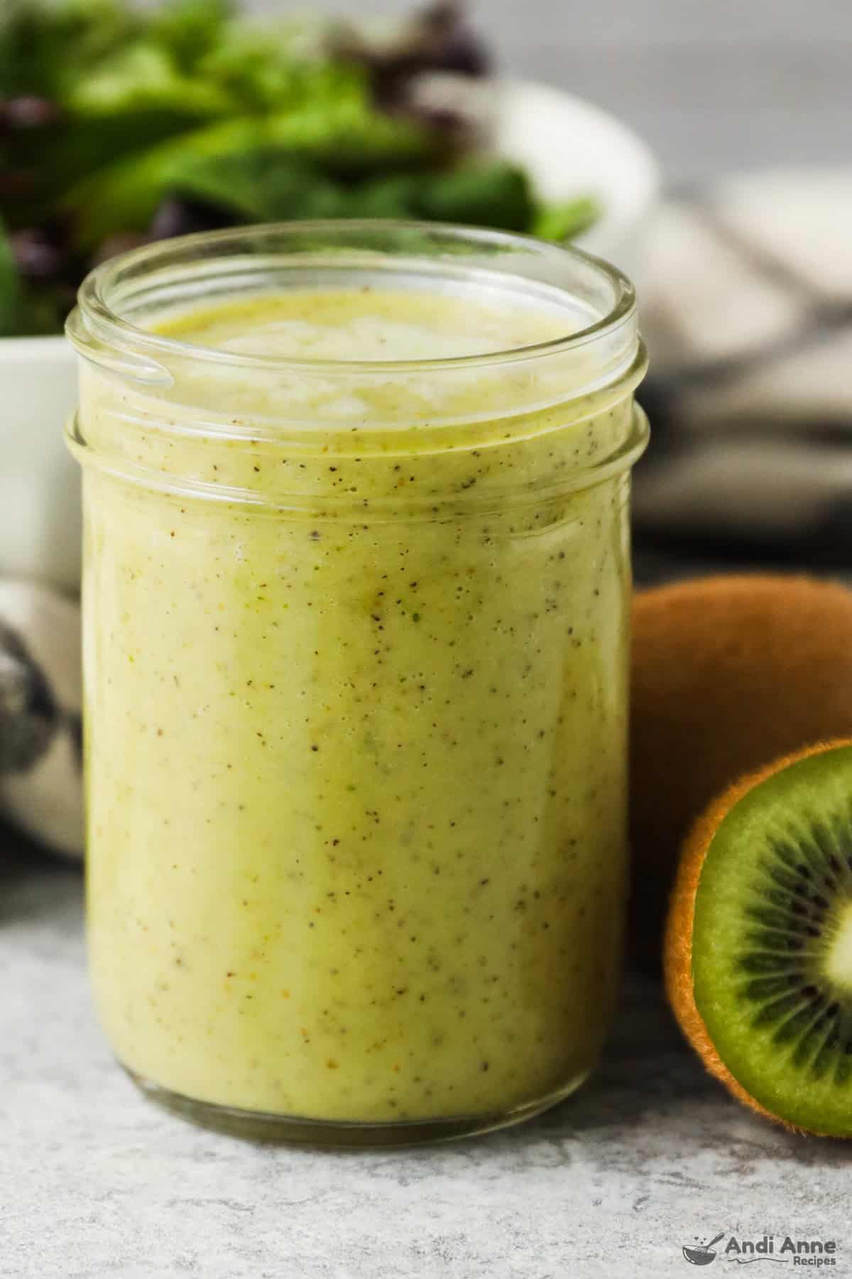 A mason jar full of kiwi citrus salad dressing.