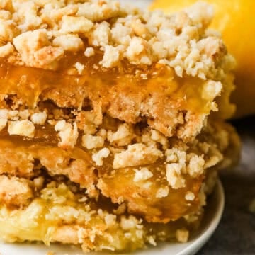 A stack of lemon bars on a plate.