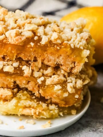 A stack of lemon bars on a plate.