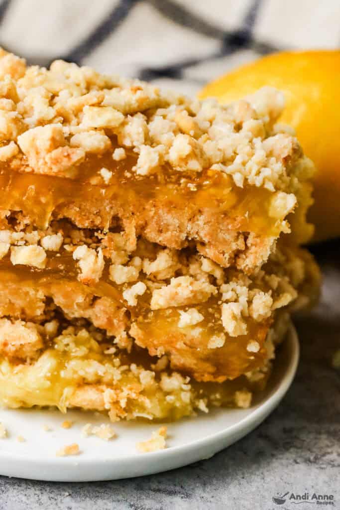 A stack of lemon bars on a plate.