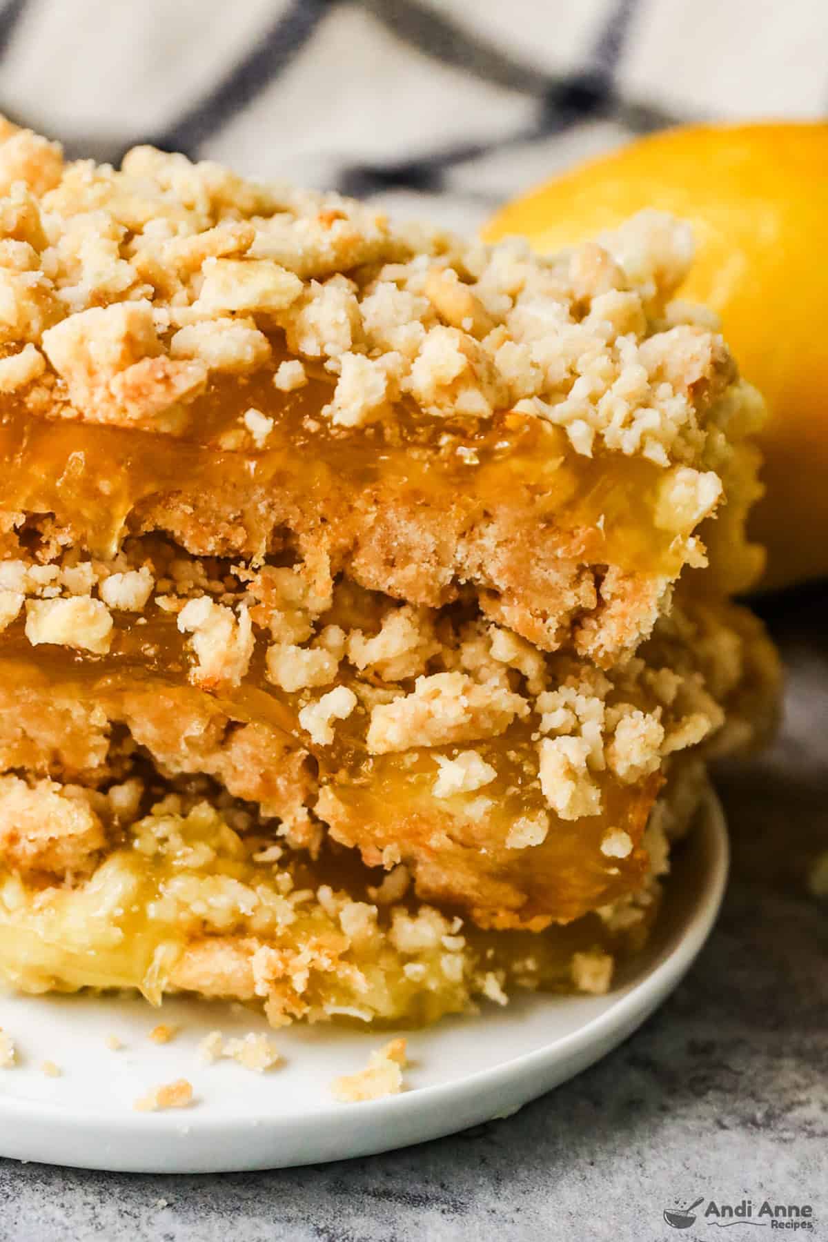 A stack of lemon bars with a soda cracker crust on a plate.