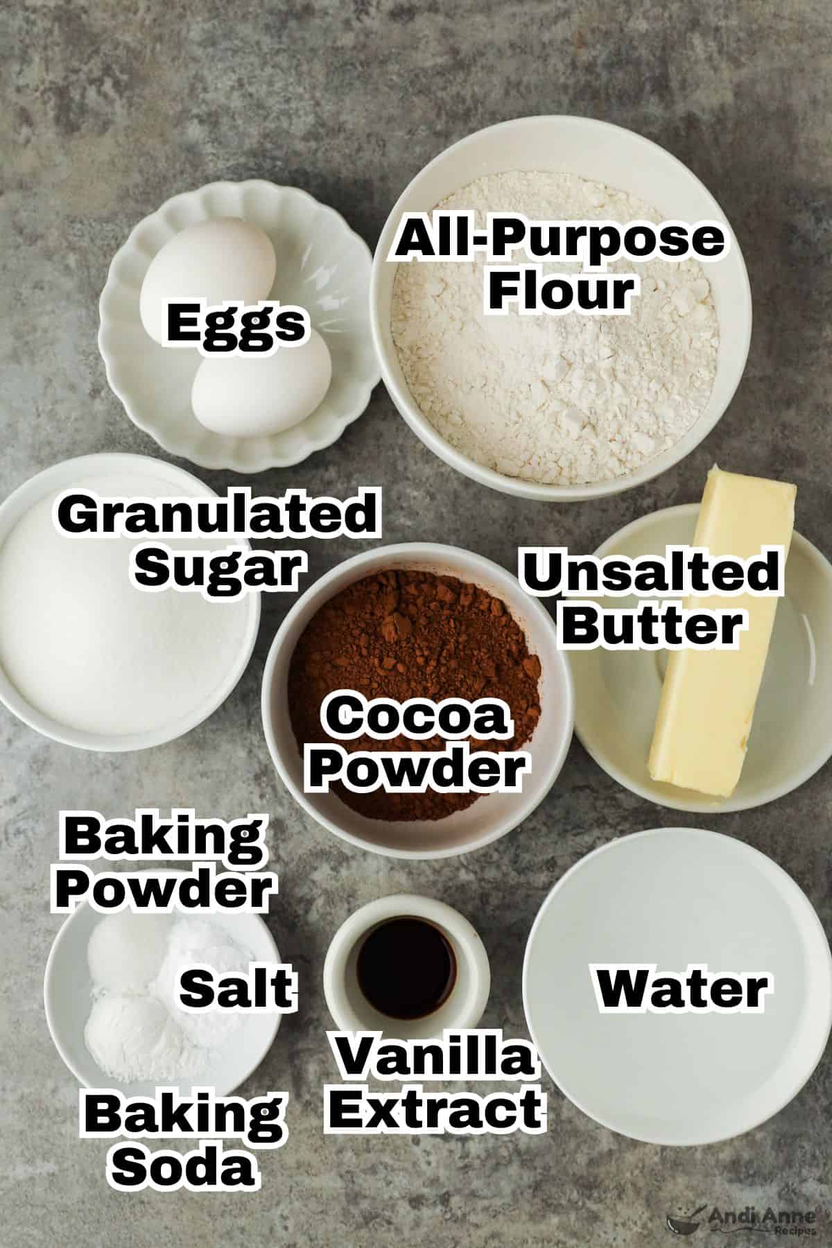 The ingredients to make old-fashioned chocolate cake are in small individual bowls.