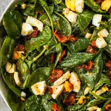 Spinach salad with bacon and chopped hard boiled egg.