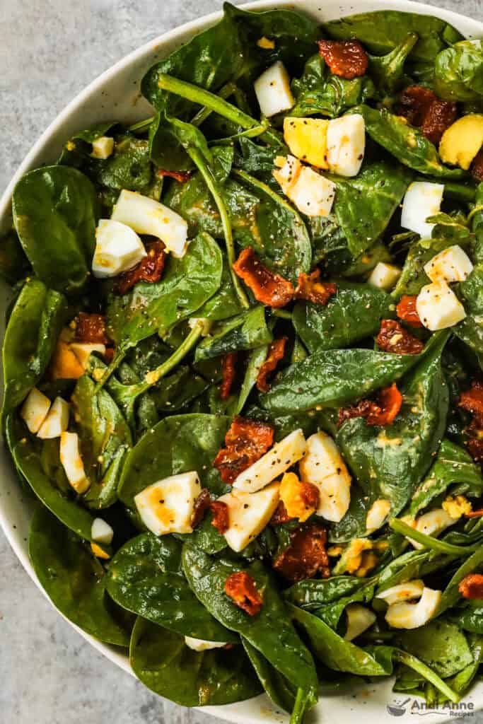 Spinach salad with bacon and chopped hard boiled egg.
