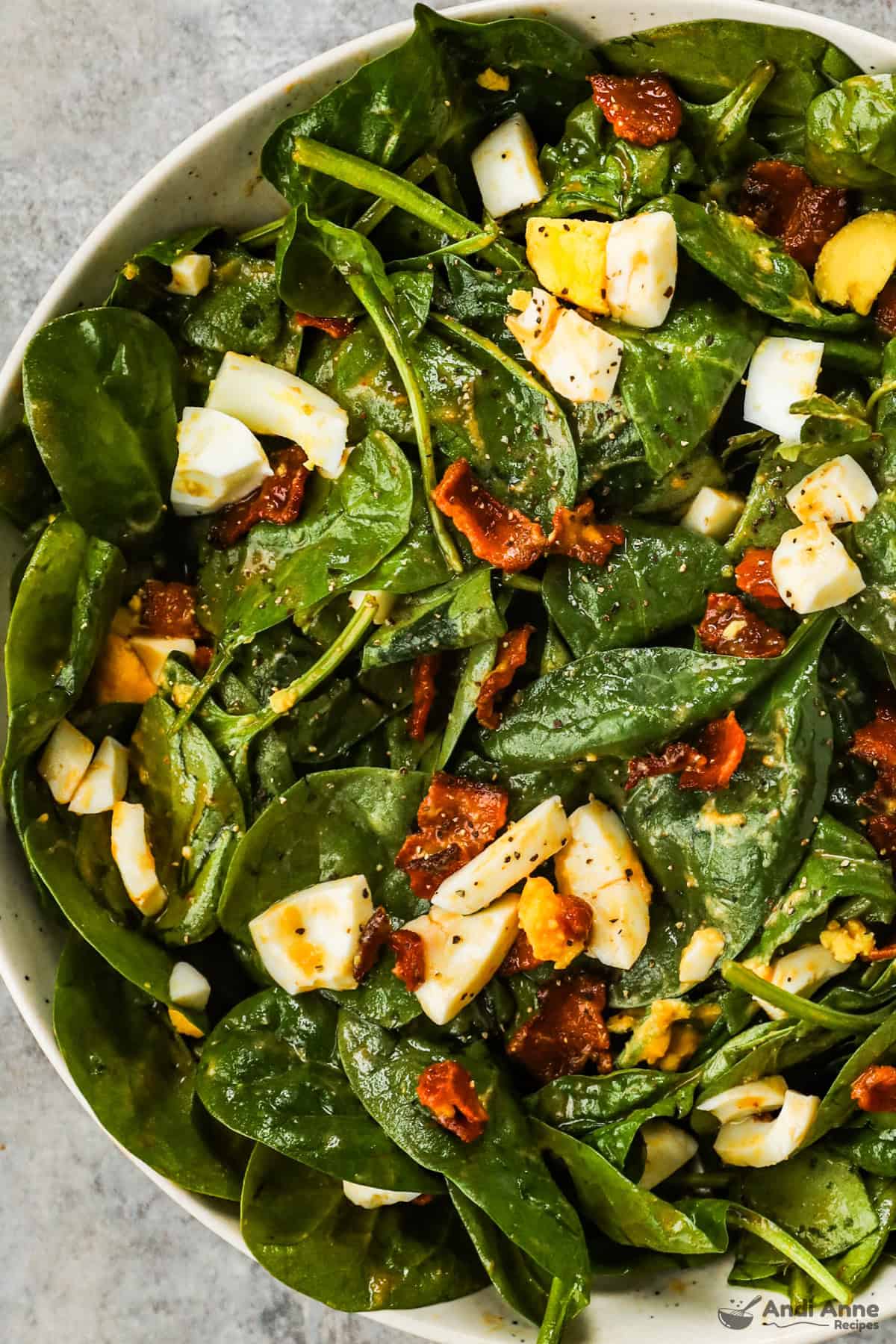 Spinach salad with bacon and chopped hard boiled egg.