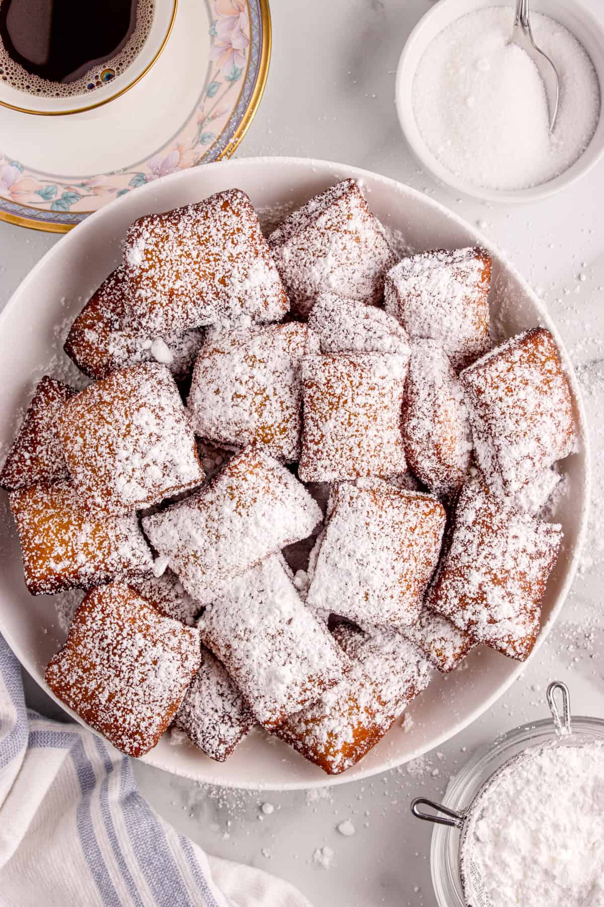 Beignets are dusted with powdered sugar.