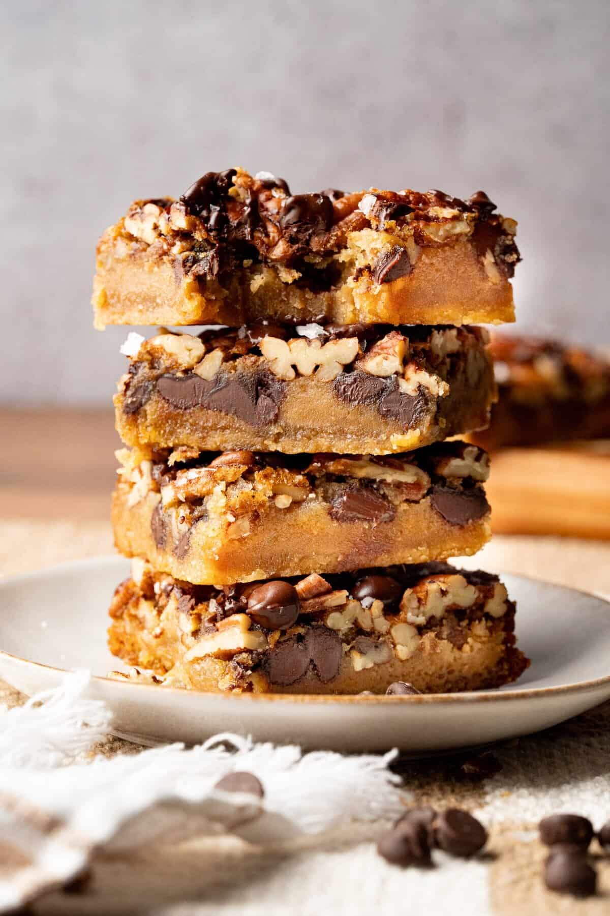 Salted chocolate pecan bars are in a stack.