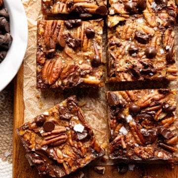 Salted chocolate pecan bars on a cutting board.