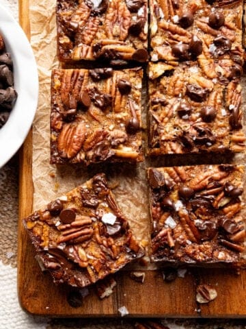 Salted chocolate pecan bars on a cutting board.