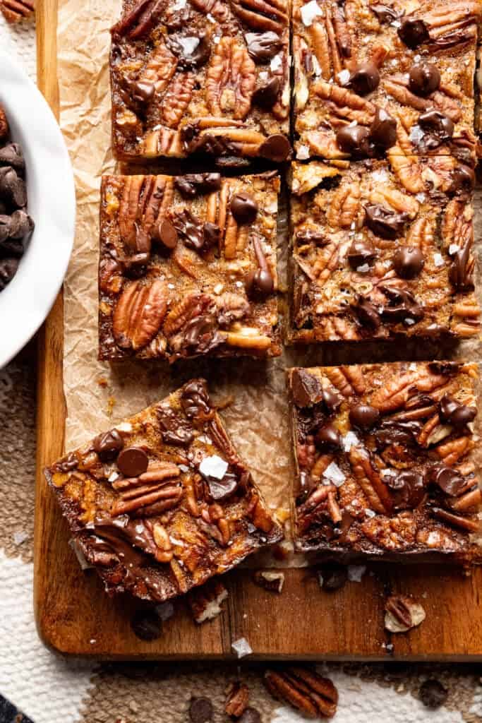 Salted chocolate pecan bars on a cutting board.