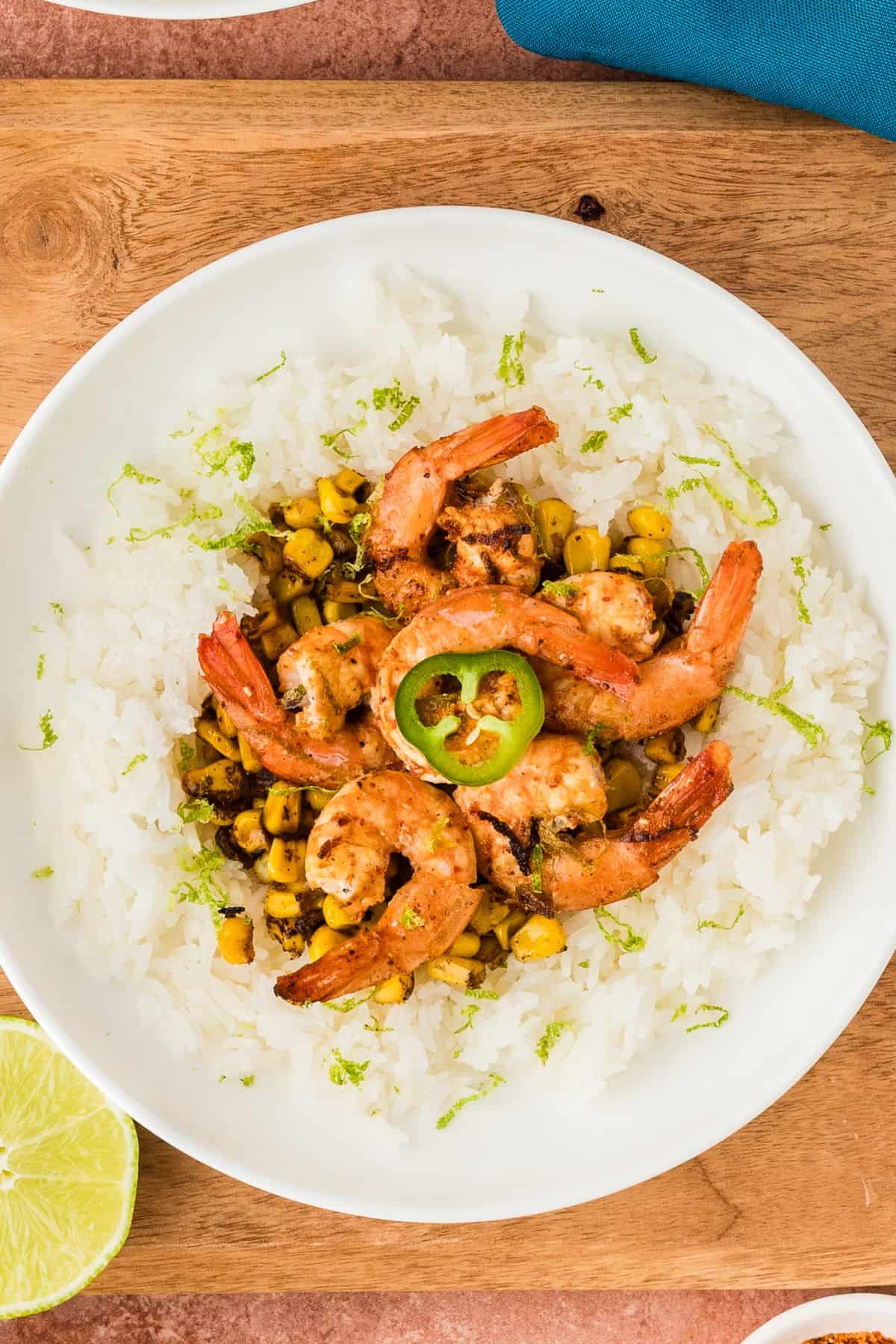 The chili lime shrimp and fire roasted corn are served over a bed of rice.