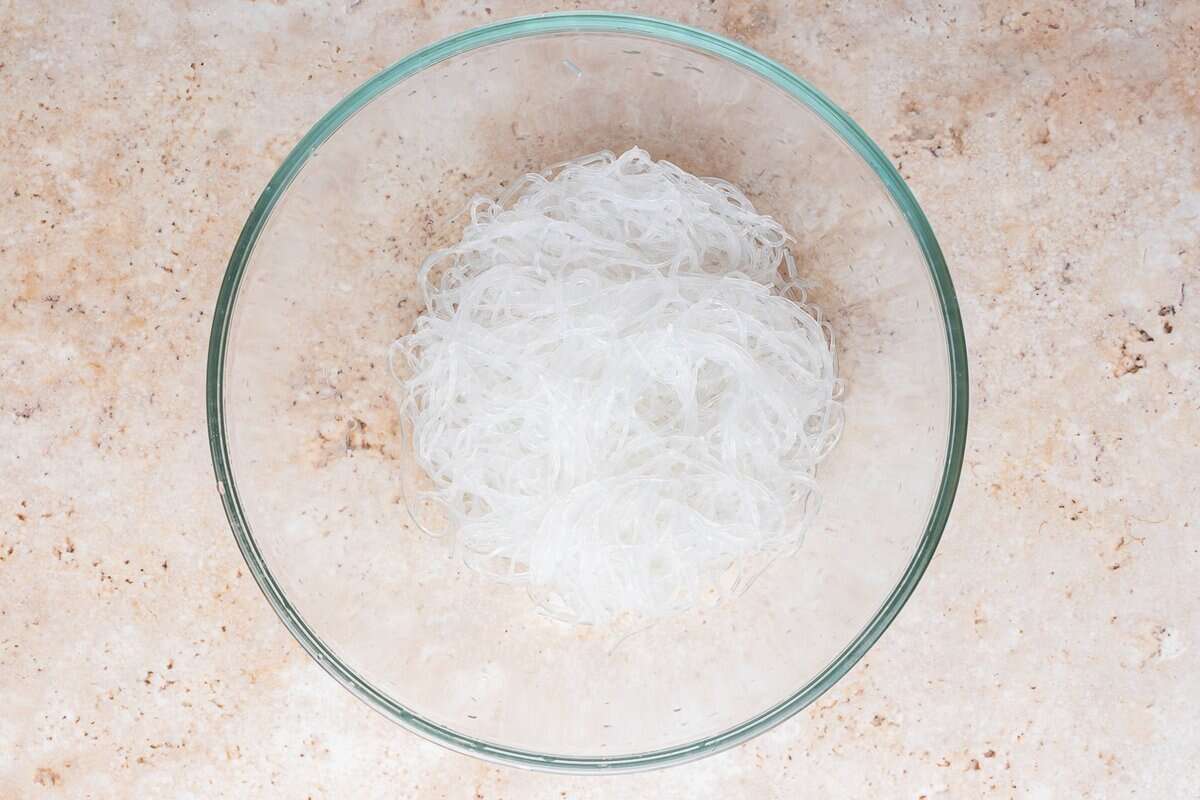 A bowl of softened glass noodles.