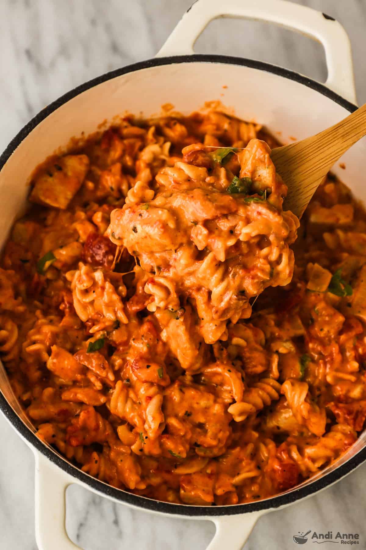 close up of pot with spoon holding bbq chicken pasta recipe
