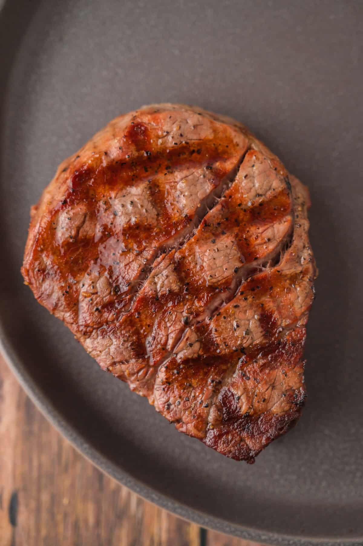 Grilled filet mignon on a plate.
