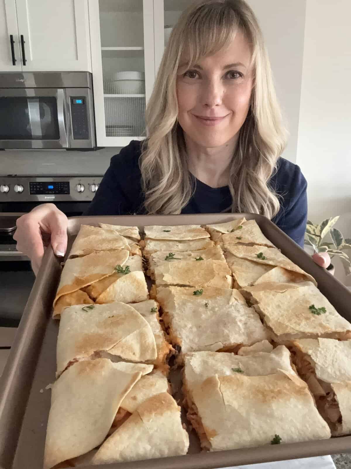 andi holding sheet pan quesadillas