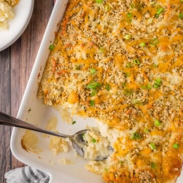 Cheesy mashed potato casserole in a large baking dish.