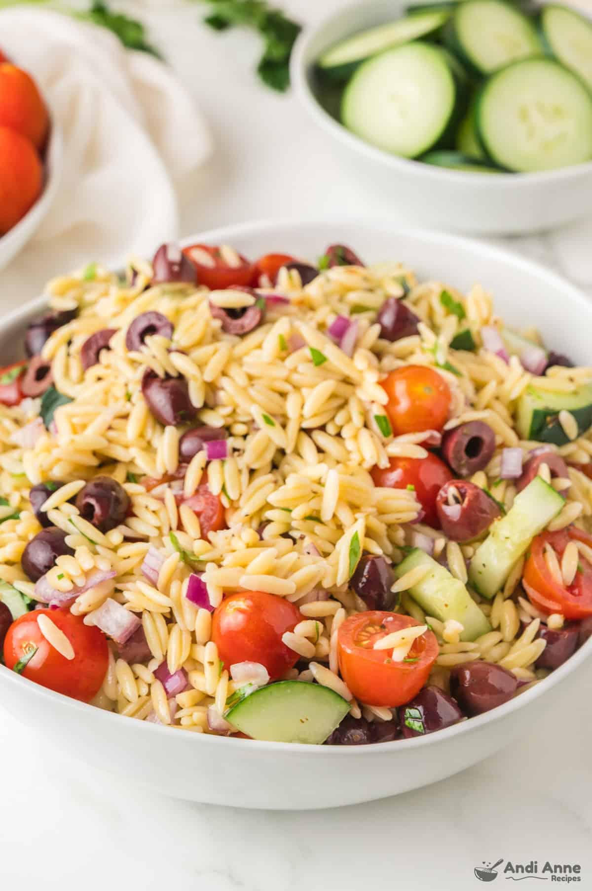 A large bowl of Mediterranean orzo salad.