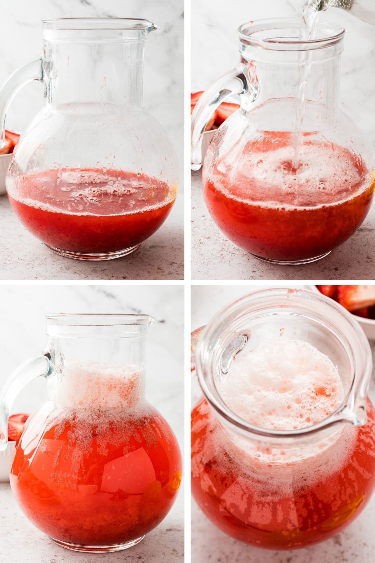 Club soda is added to chilled strawberry lemonade syrup in a large pitcher.
