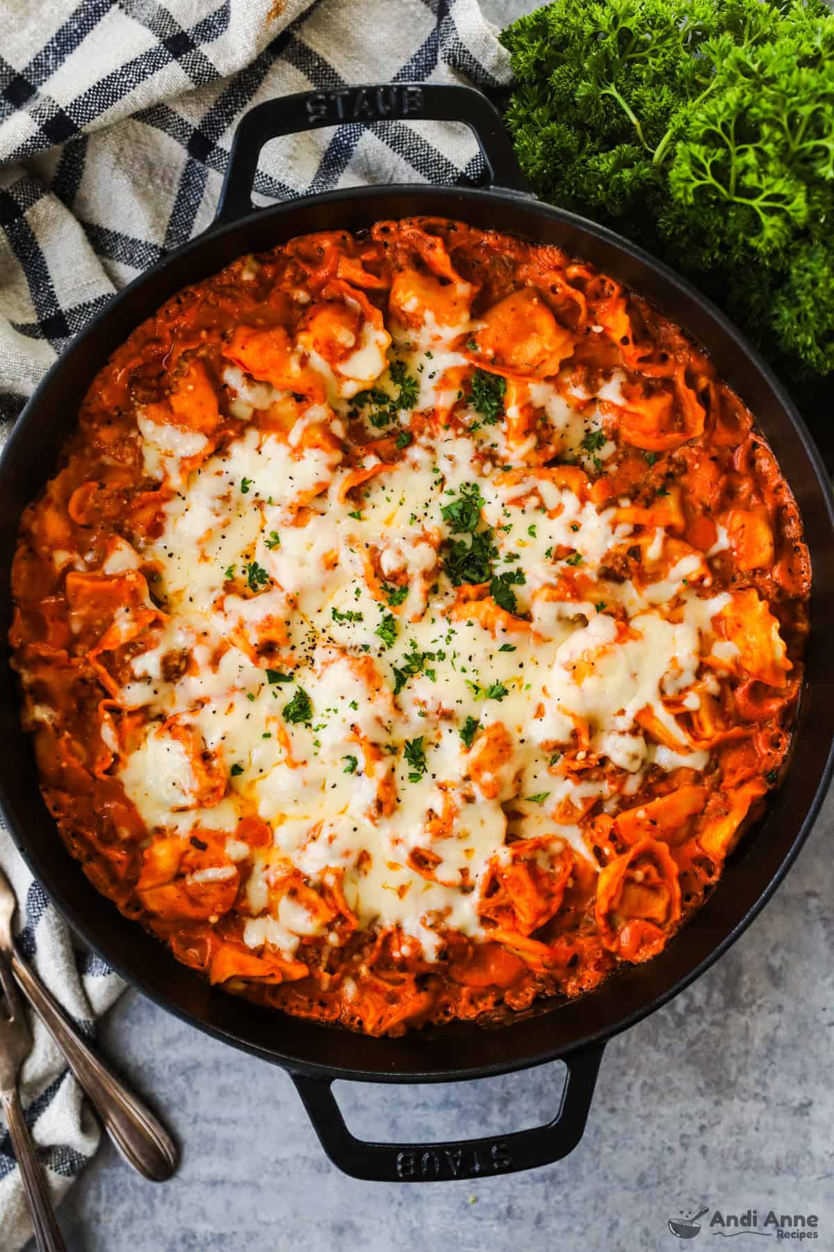 skillet of baked tortellini in sauce with melted cheese