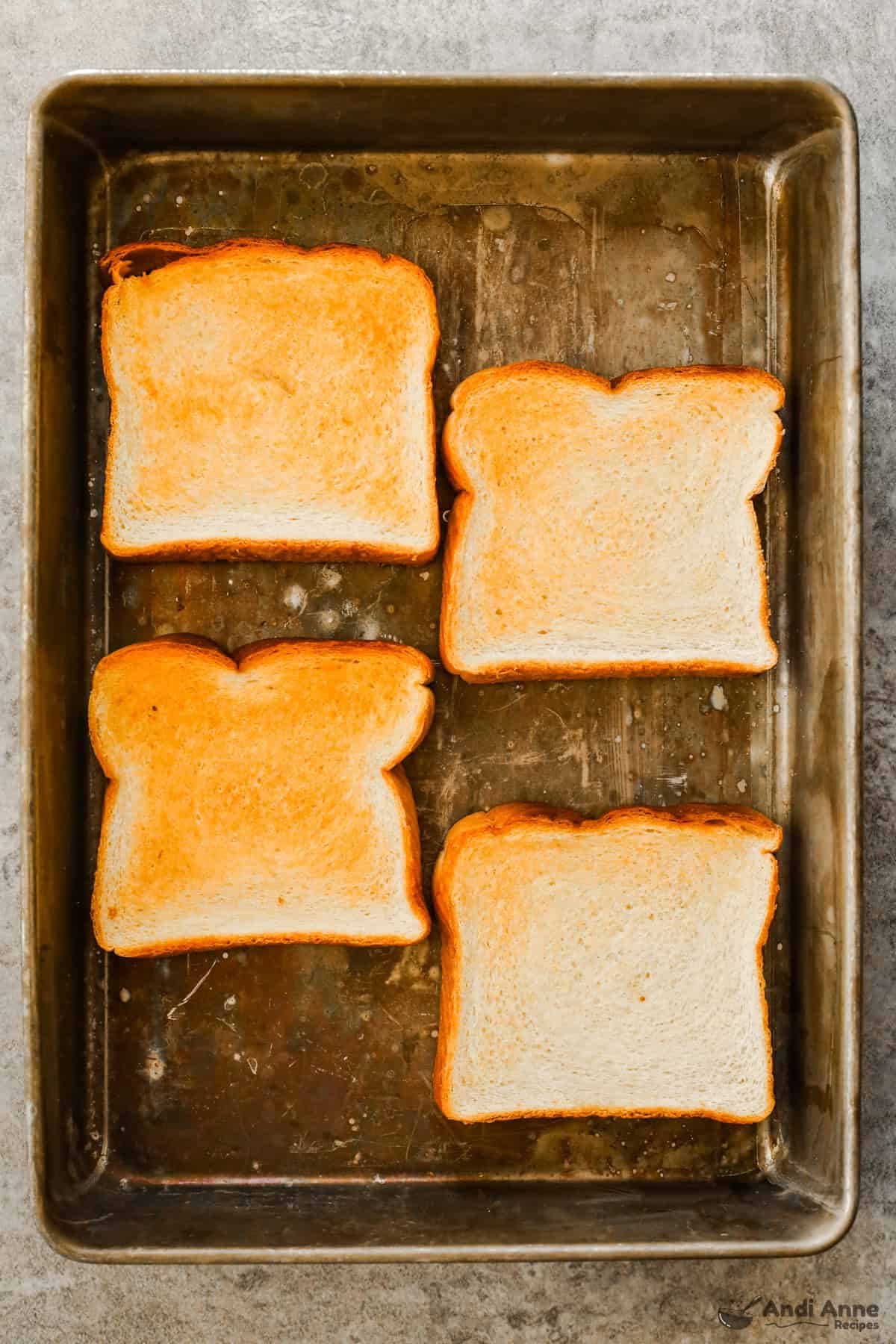 A tray with four slices of golden toasted bread.