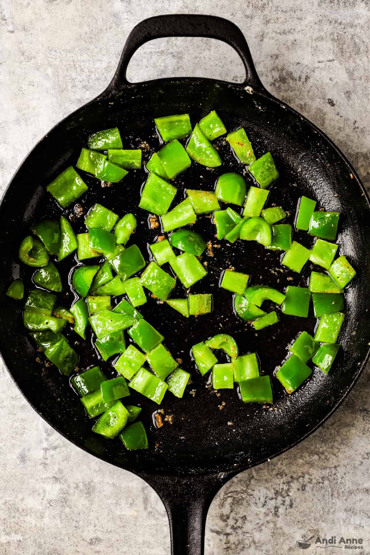The chopped bell pepper is cooked in the skillet.