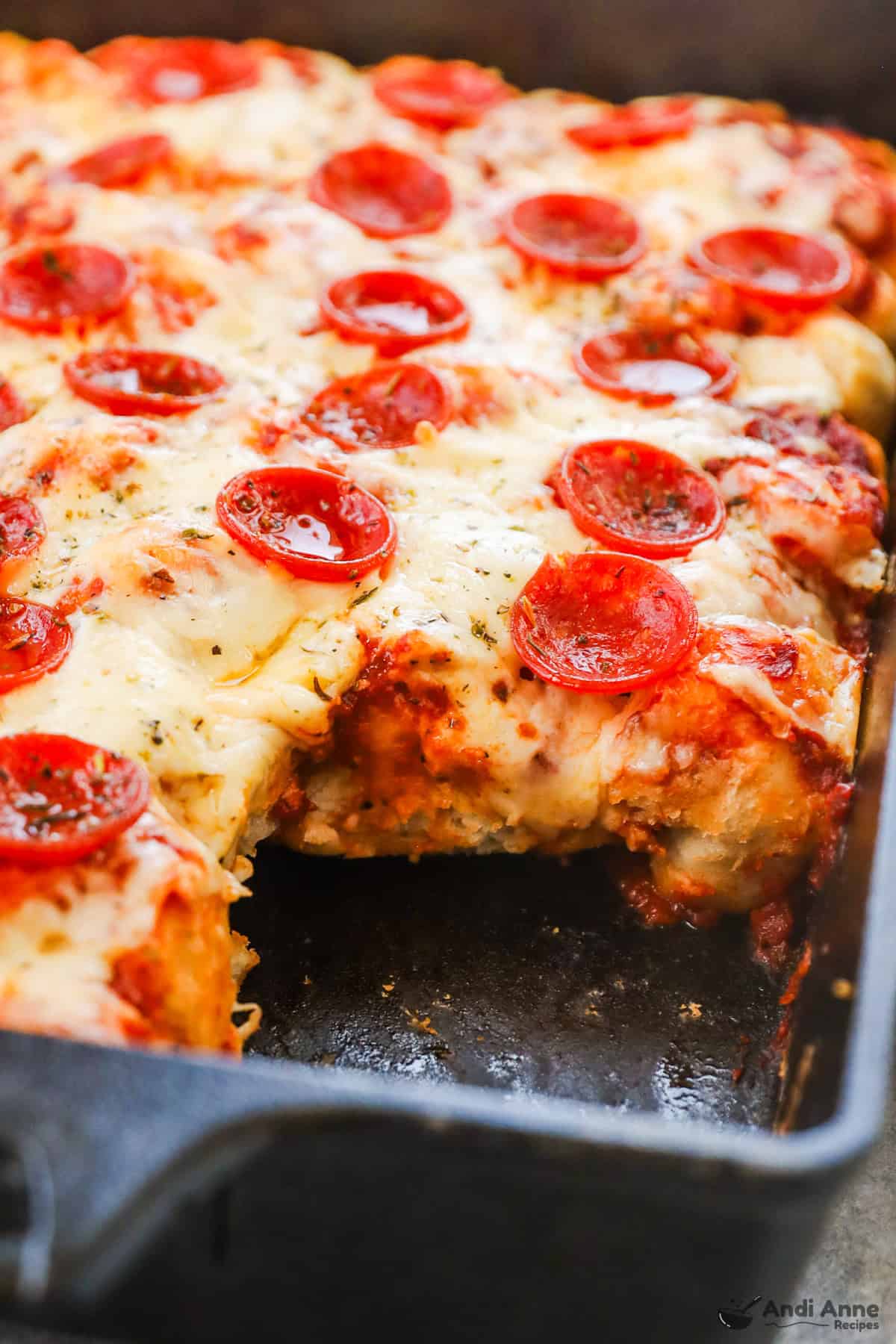 Golden baked pizza biscuit casserole with bubbly cheese and pepperoni slices just out of the oven.