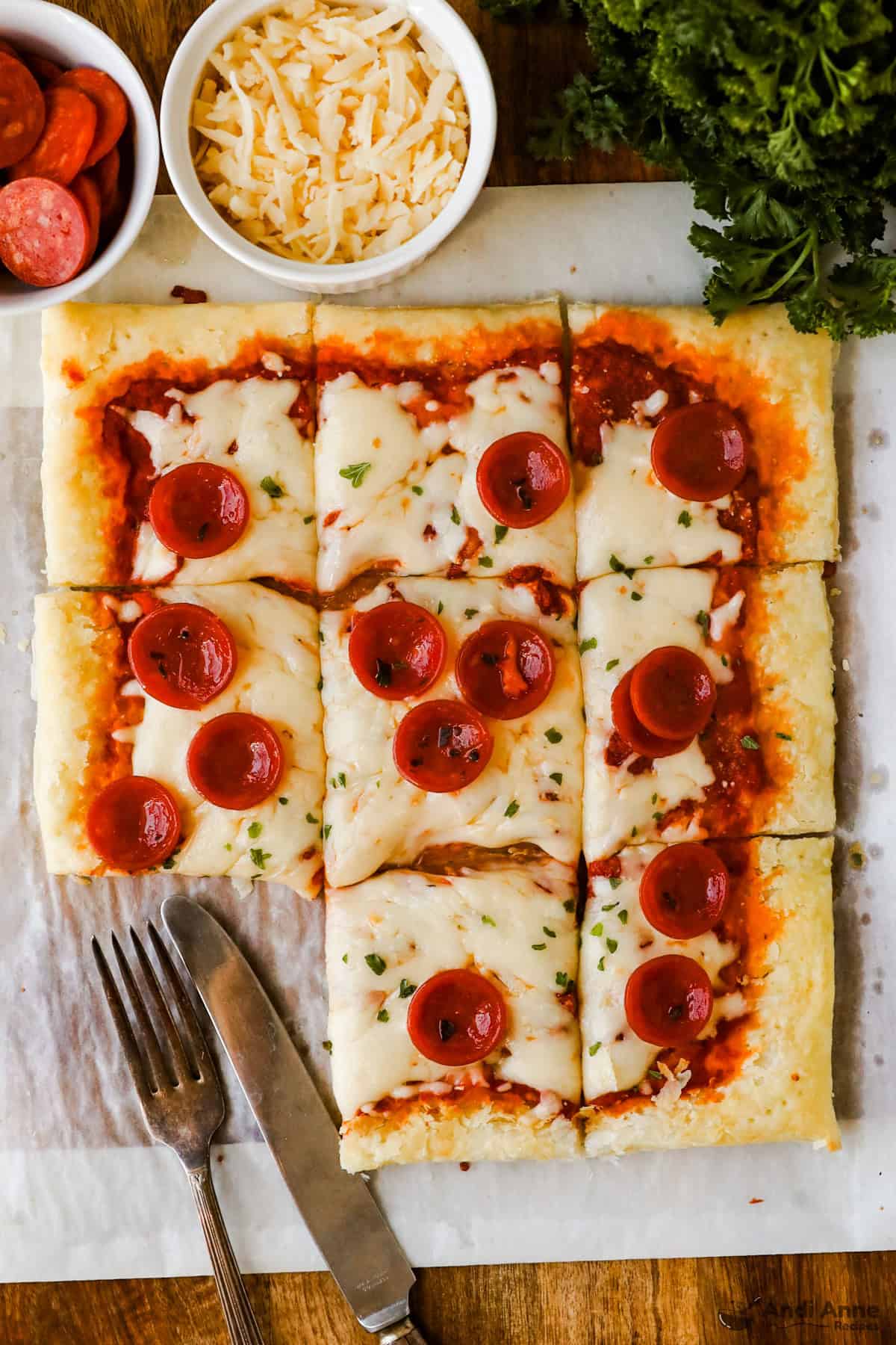 Pepperoni and cheese pizza with a puff pastry crust with one slice removed.