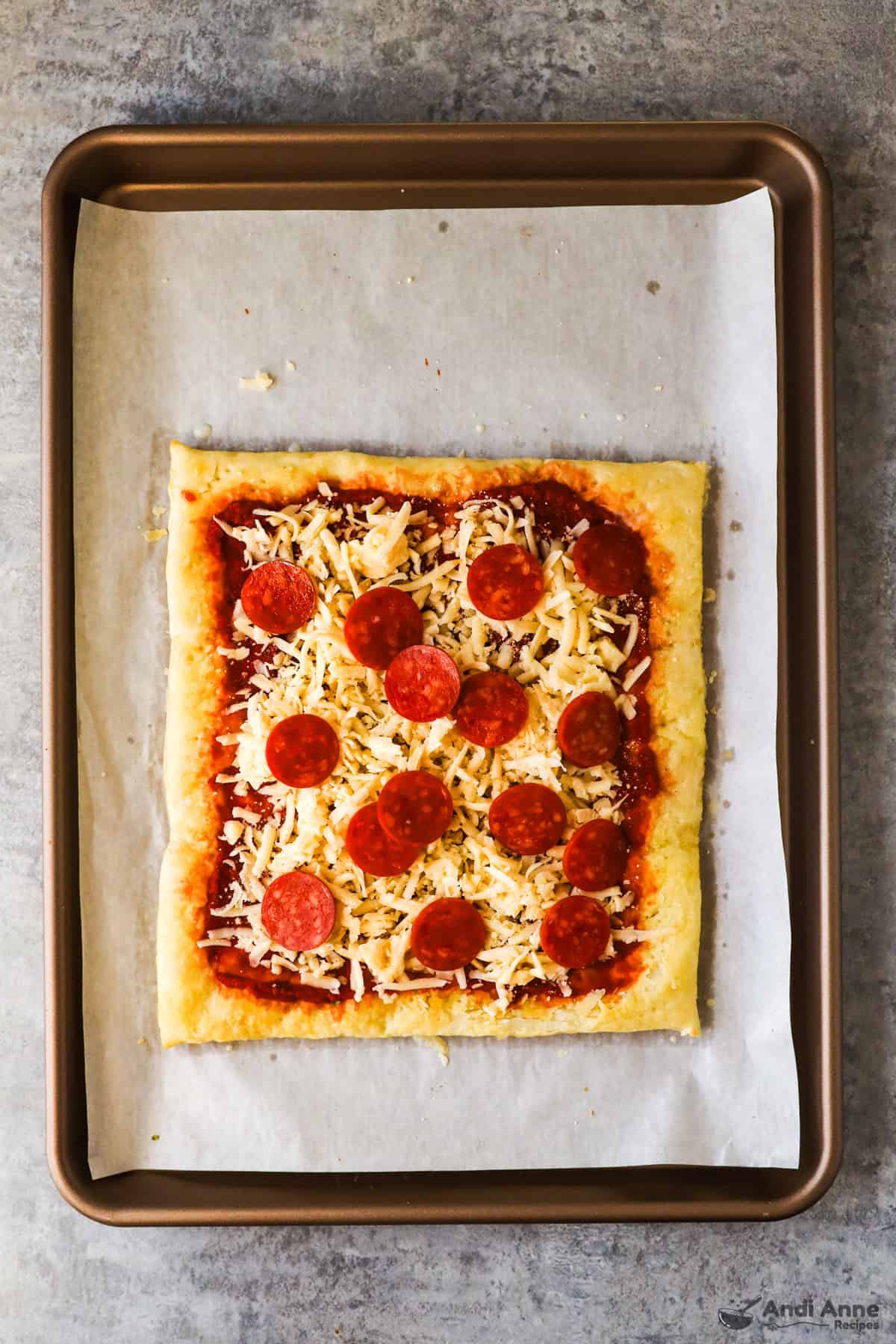 Flaky puff pastry crust topped with pepperoni, pizza sauce, and shredded mozzarella cheese.