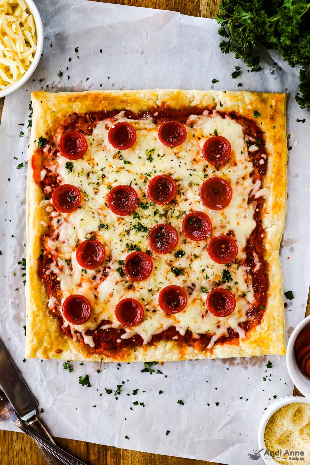 Pepperoni and cheese pizza with a puff pastry crust before slicing.