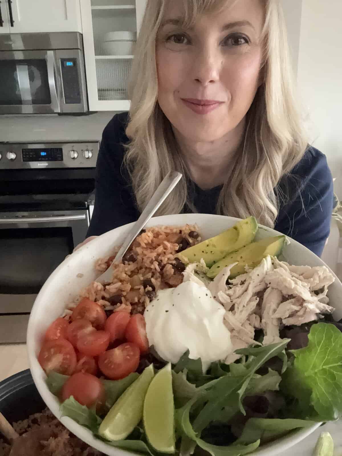 Andi is holding a burrito bowl.